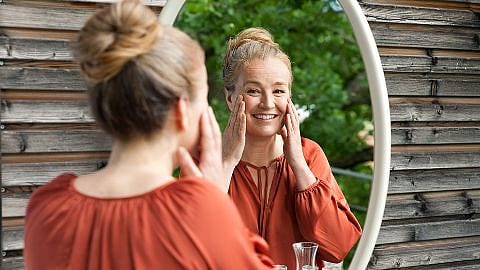woman looking into a mirror