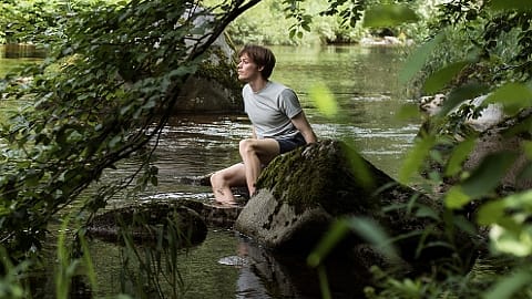 man sitting at river